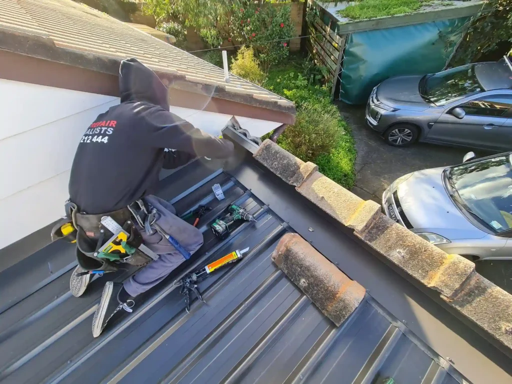 Skilled roof repair specialist repairing roof shingles