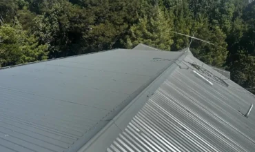 Roof repair contractor inspecting roof damage